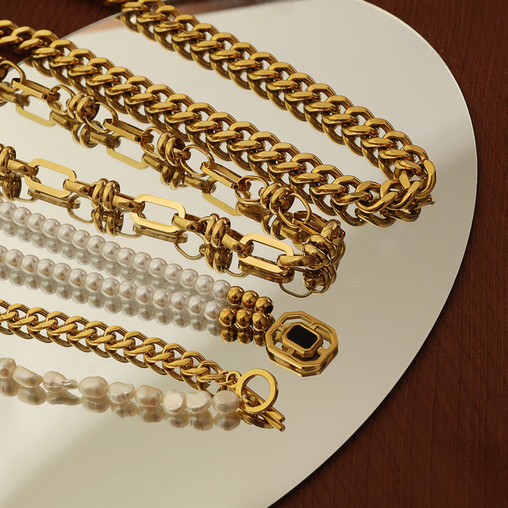 Pressie Chunky Gold Link Statement Necklace, 18K gold plated stainless steel with a collection of other necklaces.