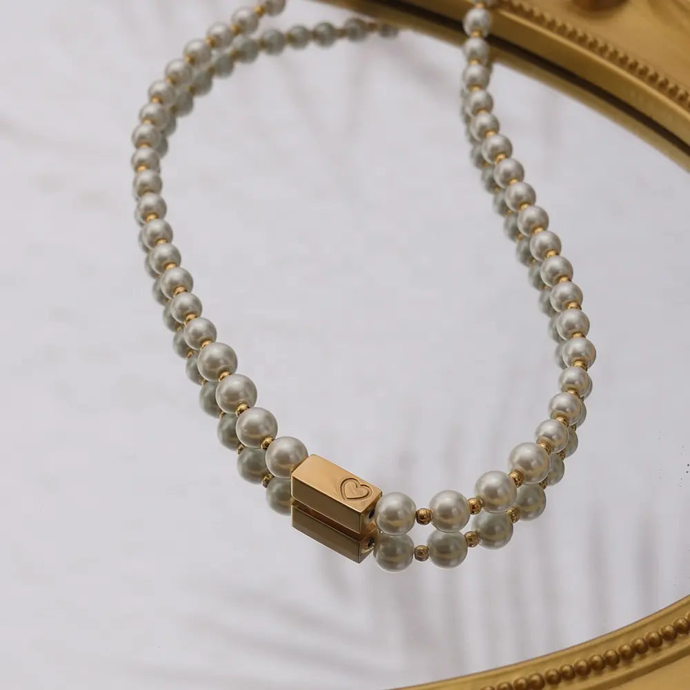 Pearl Gold Heart Necklace, featuring a timeless design with lustrous pearls, gold accents, and a charming gold heart, perfect for any occasion.