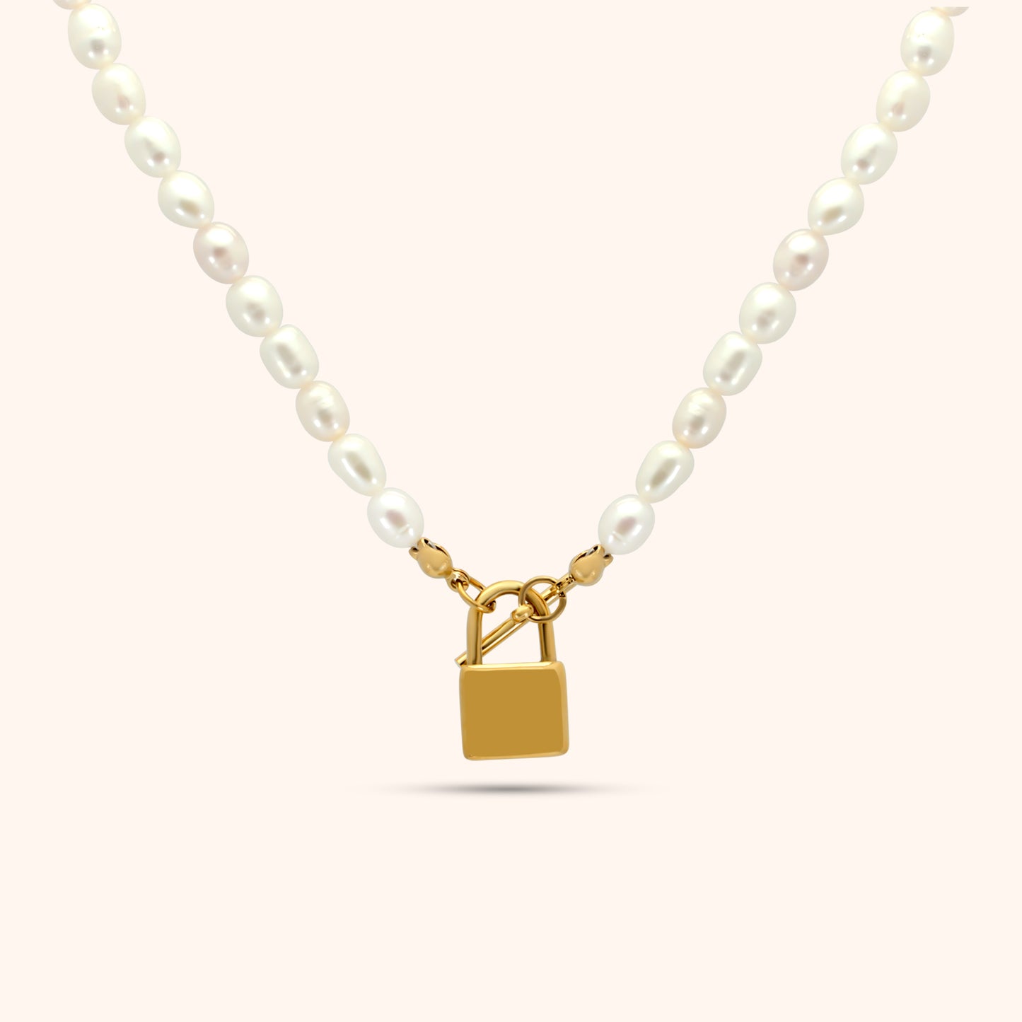 Pearl necklace with gold lock pendant in the center, featuring oval freshwater pearls and 18k gold plated stainless steel hardware