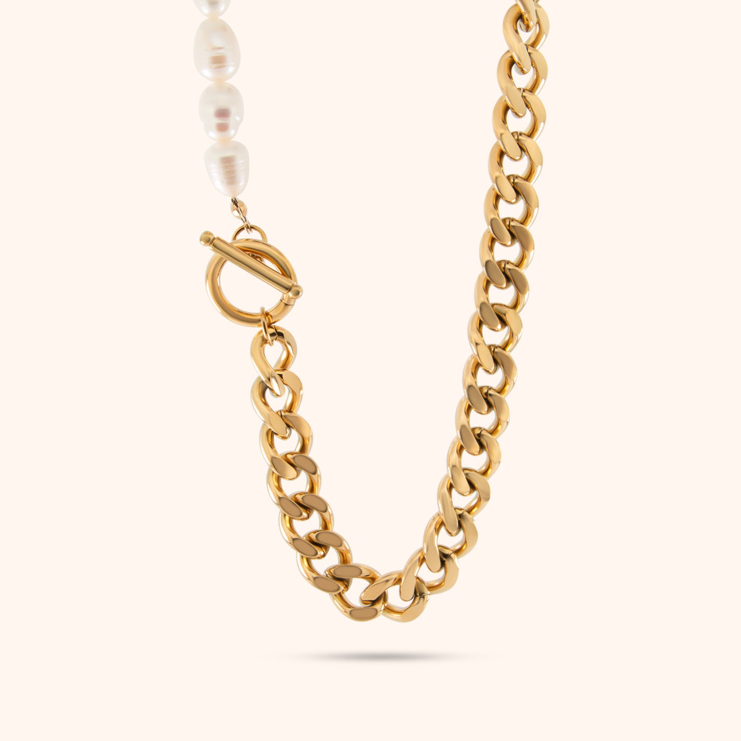 Close-up of the Lumina Link Necklace, a gold Cuban chain necklace featuring evenly spaced pearl accents.
