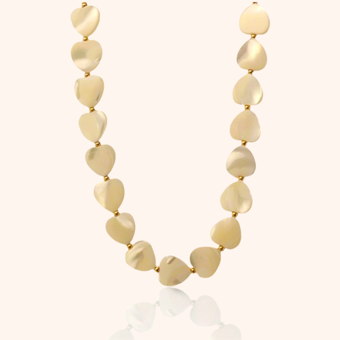 Close-up of a Mother of Pearl Heart Necklace featuring delicate, heart-shaped mother-of-pearl beads with a soft, iridescent glow.