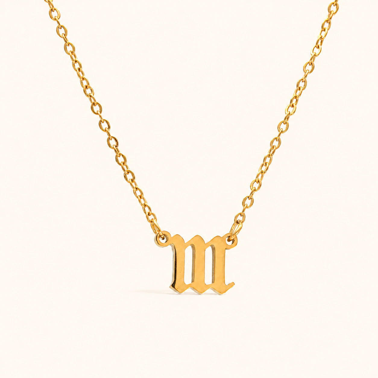 Gold necklace with a '111' pendant on a white background
