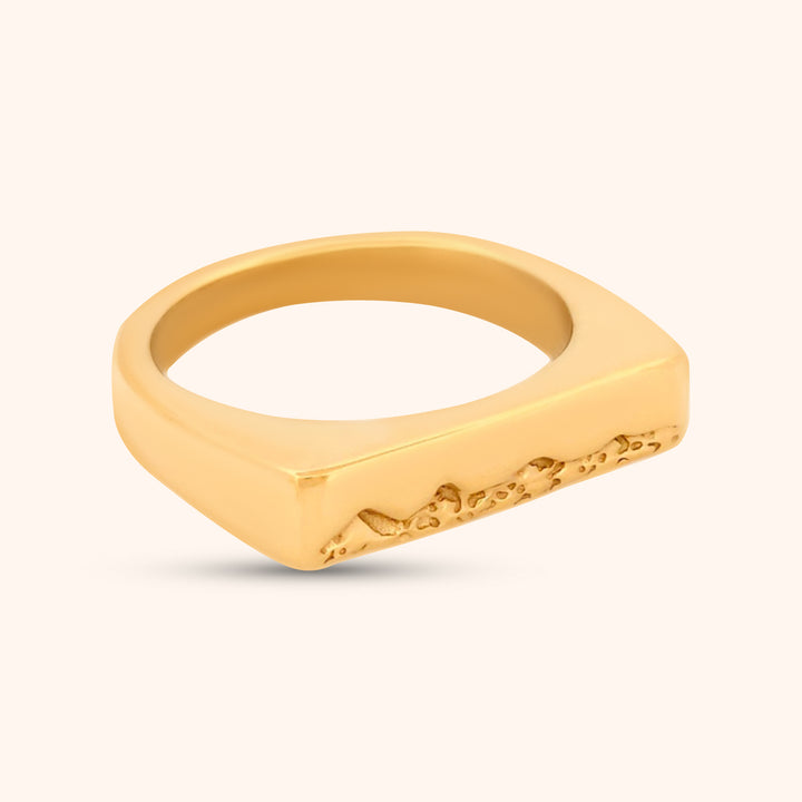 Angled view of the Kailua Ring, highlighting the clean lines of the gold band and the unique, engraved triangle mountain details on the rectangular top.
