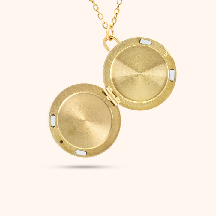 Interior view of the PRESSIE Treasured Locket; 18k gold plated, showing the open locket with space for photos and magnetic closures.