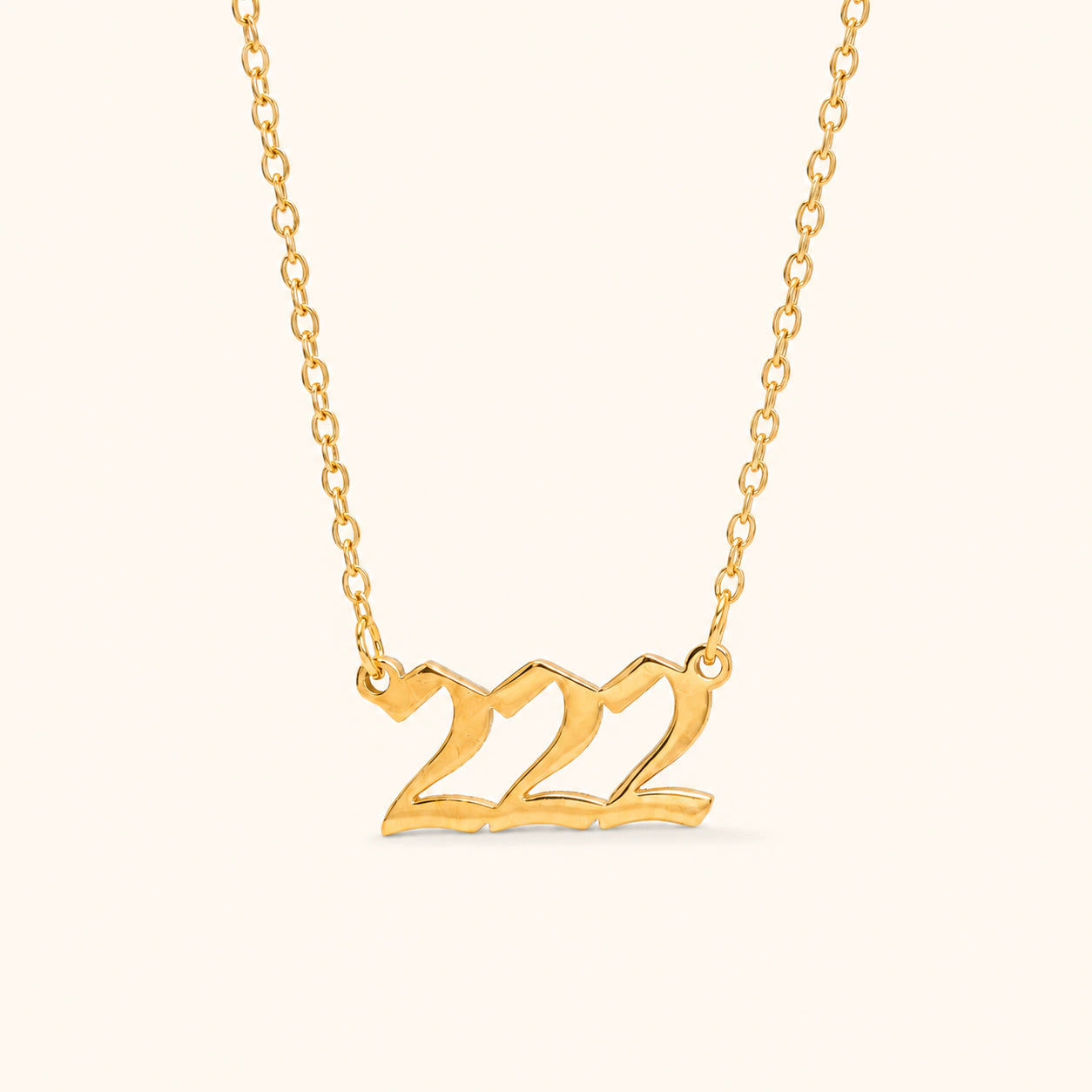 222 18k gold angel number necklace with bold numeral pendant on a gold link chain.