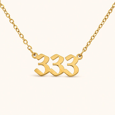 333 18k gold angel number necklace with bold numeral pendant on a gold 