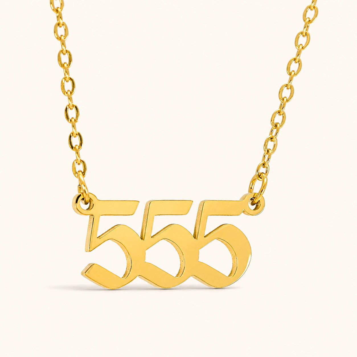 555 18k gold angel number necklace with bold numeral pendant on a gold necklace