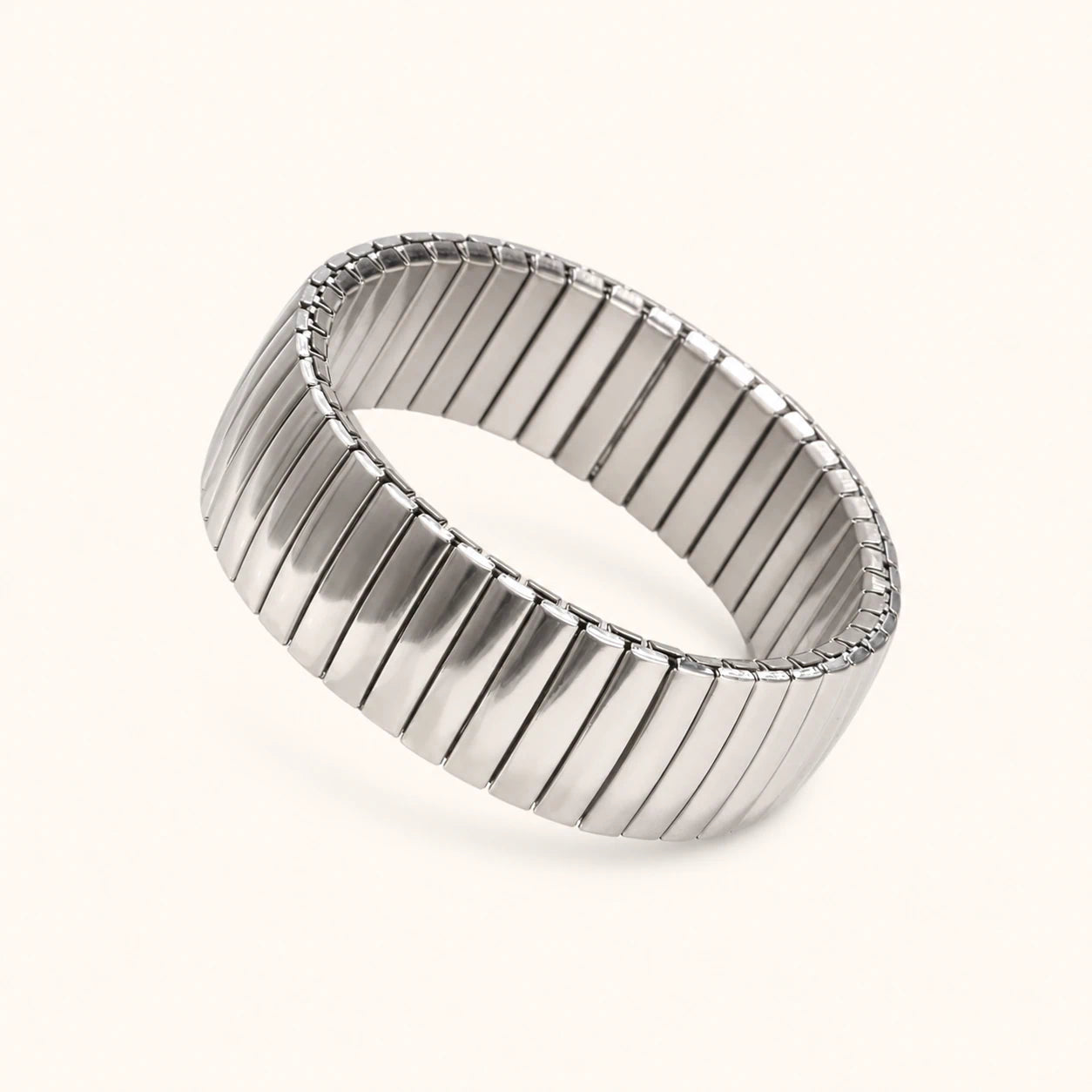 Silver bracelet with a ribbed design on a white background