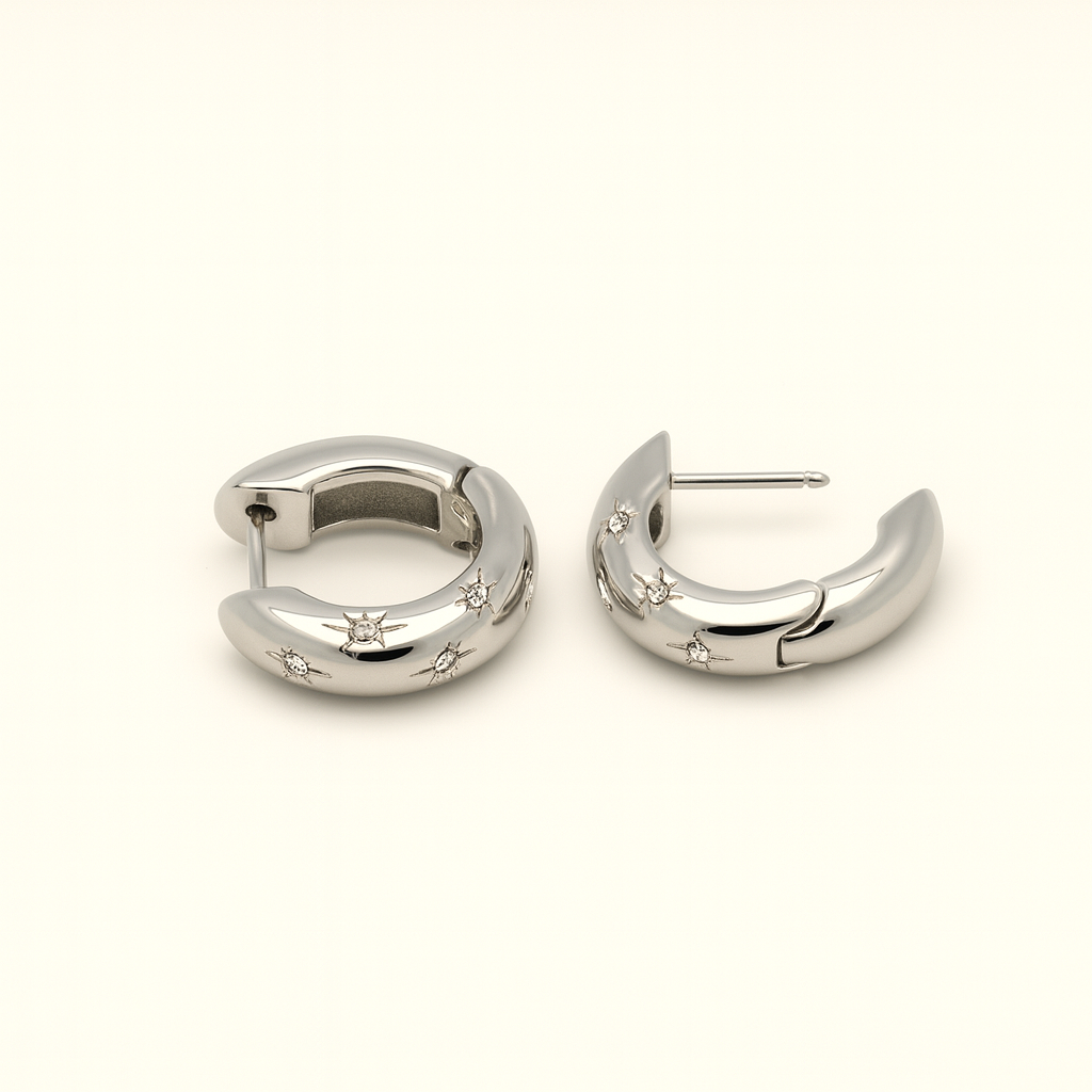 Silver hoop earrings with small stones on a white background