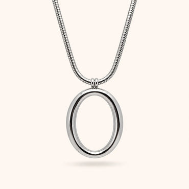 A silver snake chain necklace with a polished oval pendant, shown against a solid off-white background.