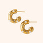 Chunky gold hoop earrings adorned with both pearls and sparkling crystals, creating a luxurious blend of texture and shine.
