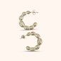 Detailed view of gold balloon hoop earrings showcasing their bold, contemporary design and polished finish
