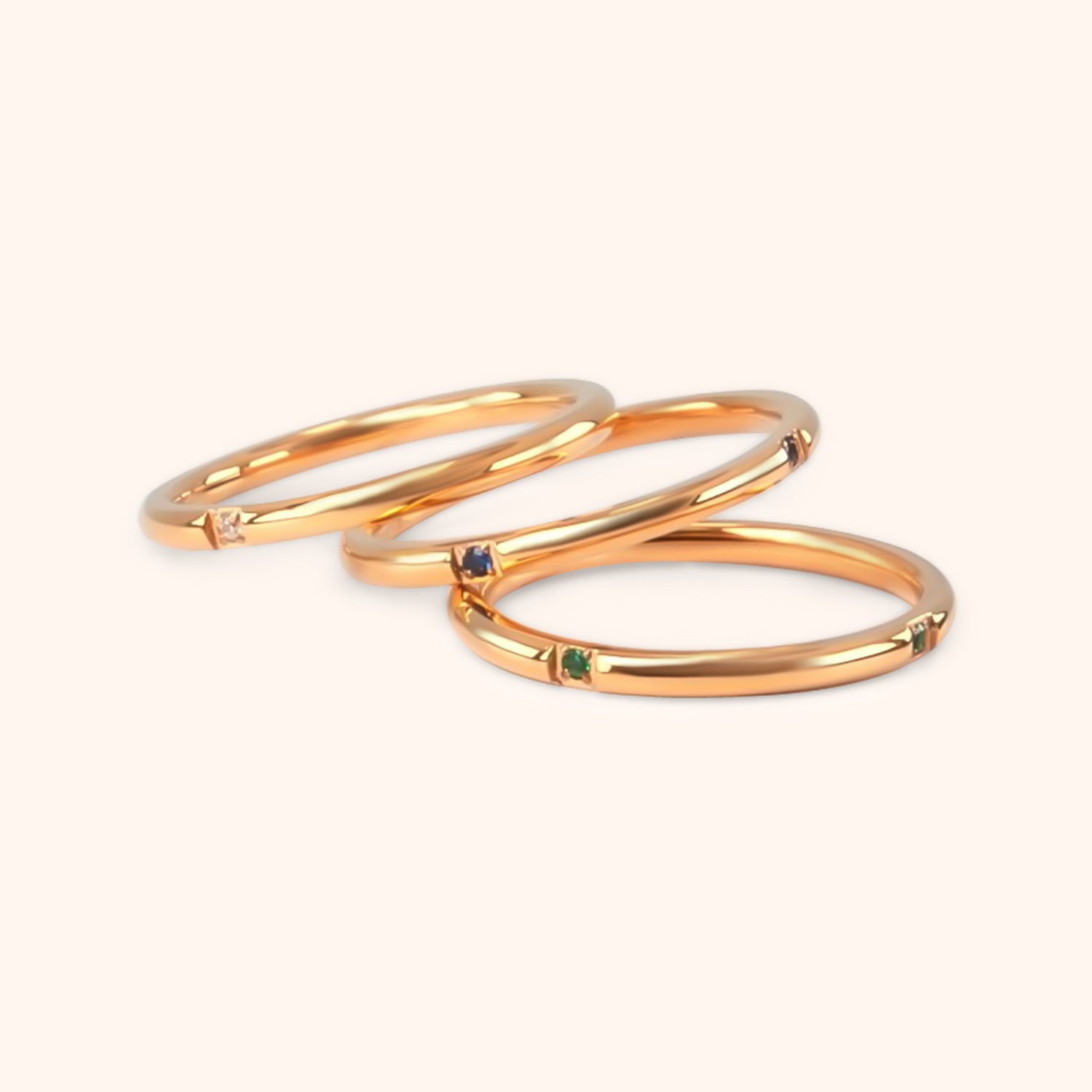 The Unity Ring Set, showcasing individual delicate gold rings, possibly worn on a hand to demonstrate stacking options.