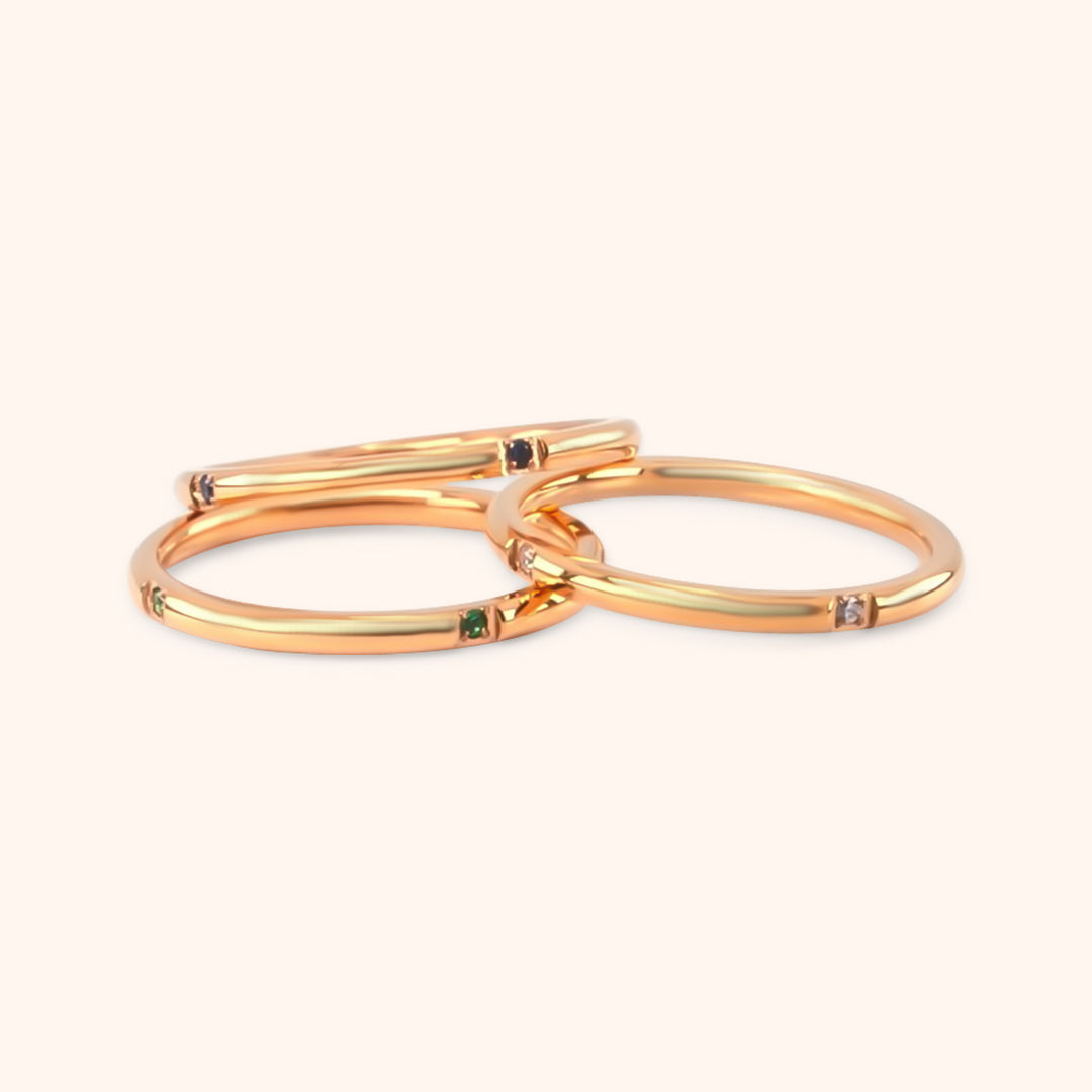 Close-up of the Unity Ring Set, showing multiple delicate gold rings stacked together.