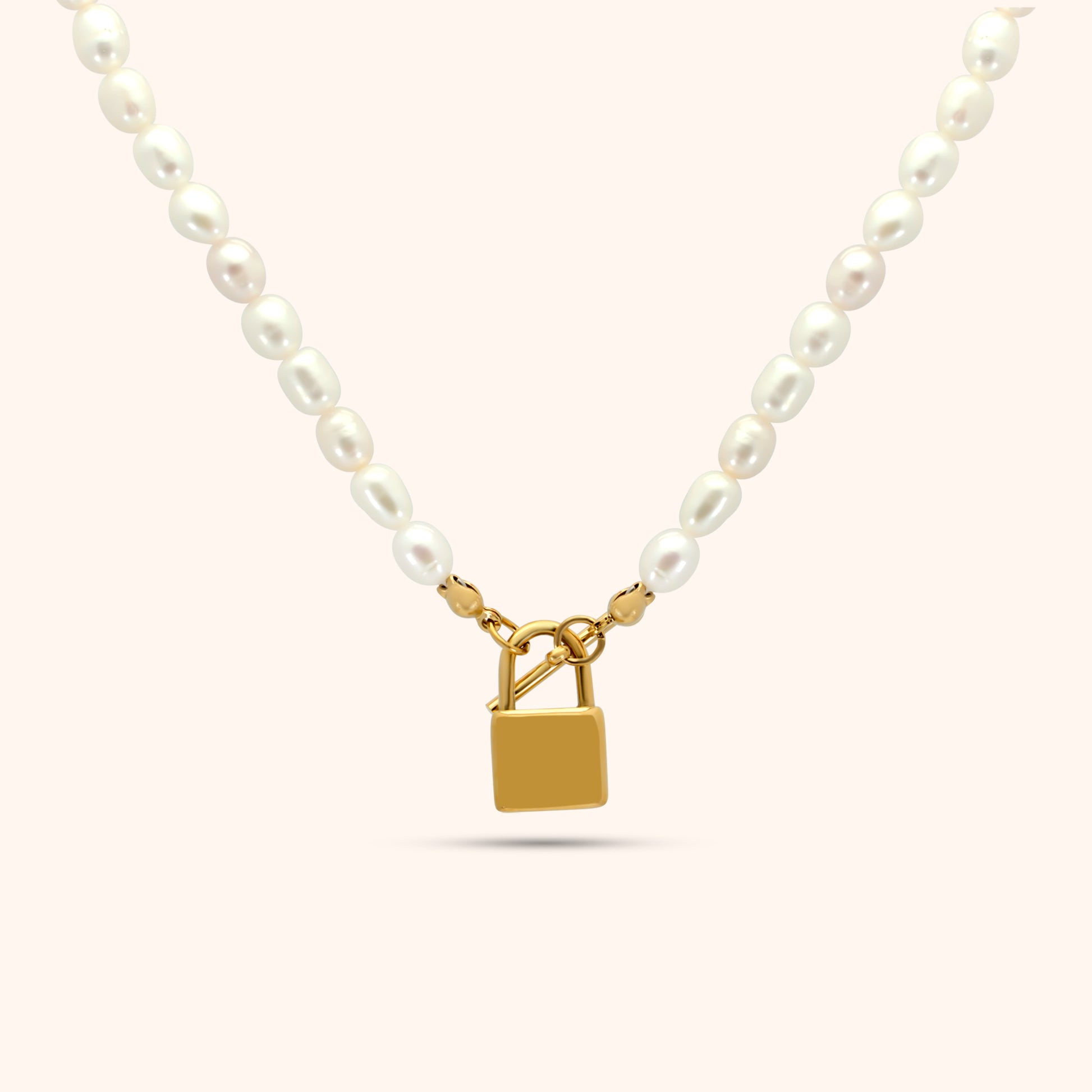 Pearl necklace with gold lock pendant in the center, featuring oval freshwater pearls and 18k gold plated stainless steel hardware