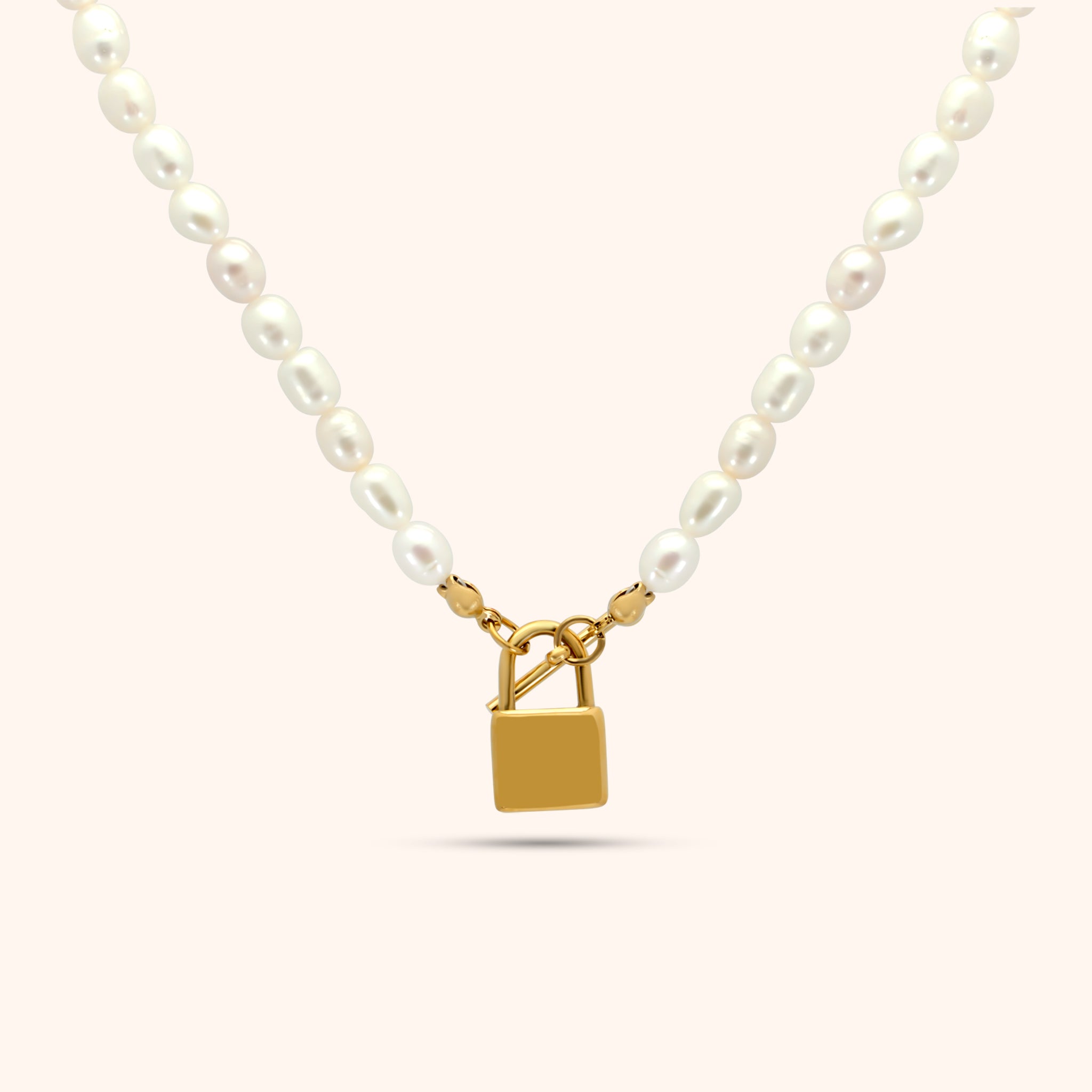 Pearl necklace with gold lock pendant in the center, featuring oval freshwater pearls and 18k gold plated stainless steel hardware