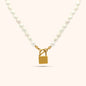 Pearl necklace with gold lock pendant in the center, featuring oval freshwater pearls and 18k gold plated stainless steel hardware