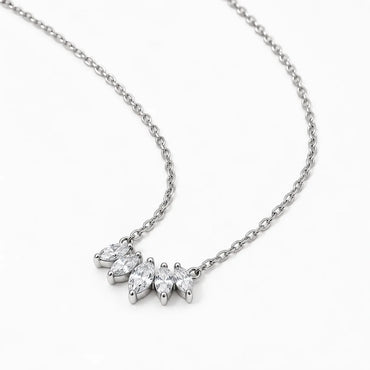 A silver-toned necklace with a delicate chain and a small cluster of marquise-cut clear gemstones in a prong setting, photographed on a clean white background.