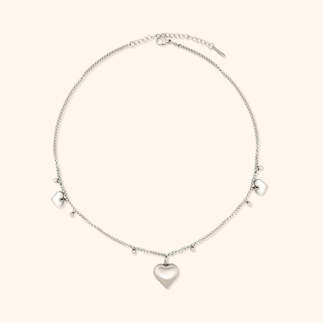 Pressie Delicate Symmetrical Heart Charm Necklace, 18K gold plated stainless steel, close-up of the heart charm details.