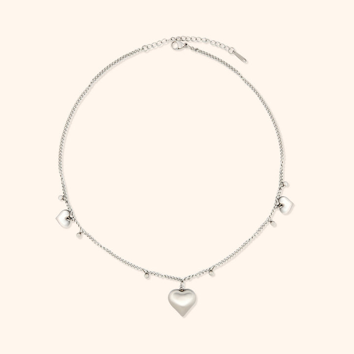 Pressie Delicate Symmetrical Heart Charm Necklace, 18K gold plated stainless steel, close-up of the heart charm details.