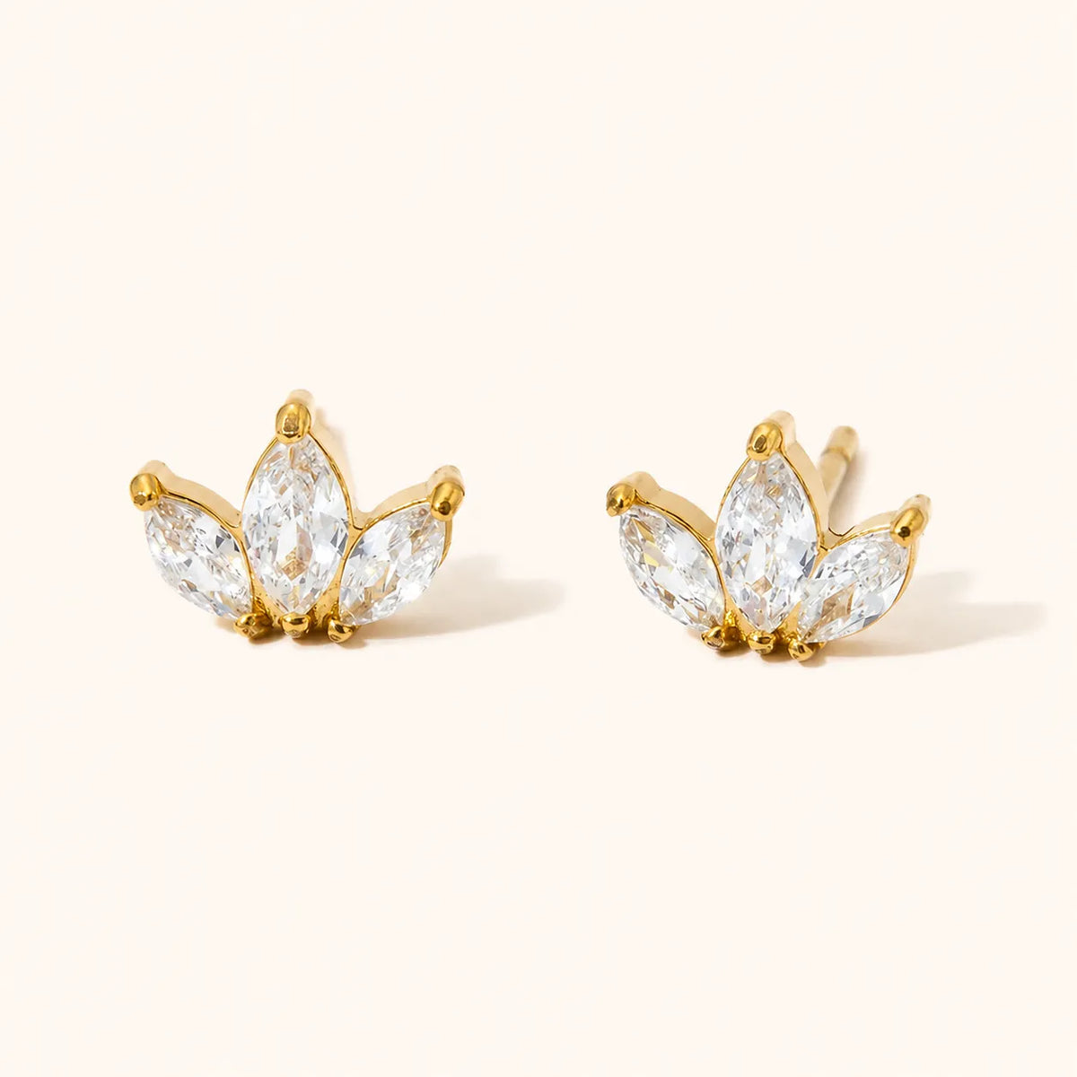 Three-stone marquise clear stud earrings in a lotus-inspired shape, available in 18k gold