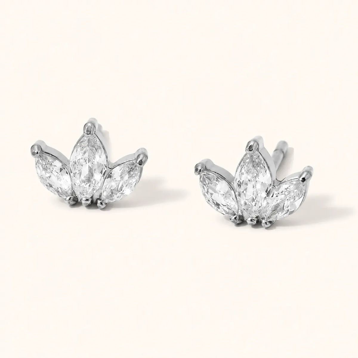 Three-stone marquise clear stud earrings in a lotus-inspired shape, available in polished stainless steel.