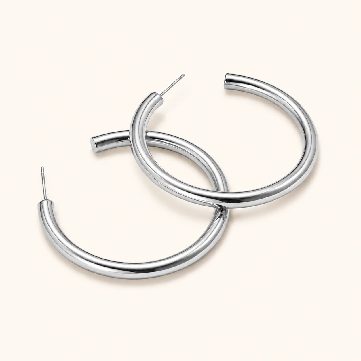Pair of silver hoop earrings on a white background