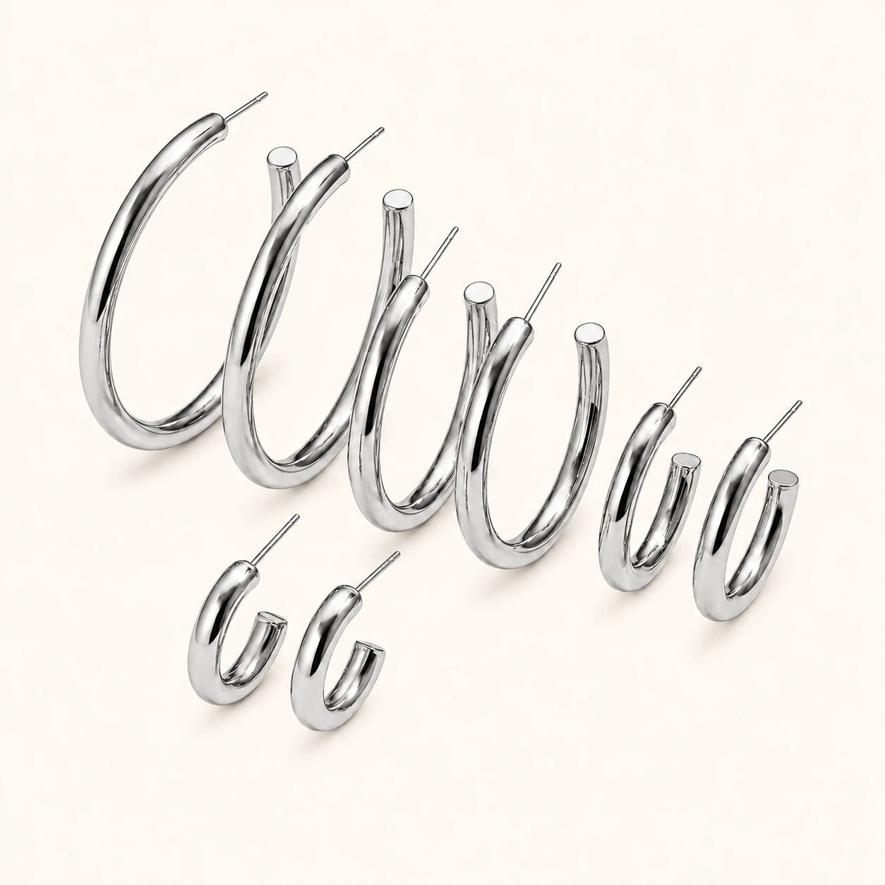 Set of silver hoop earrings on a white background