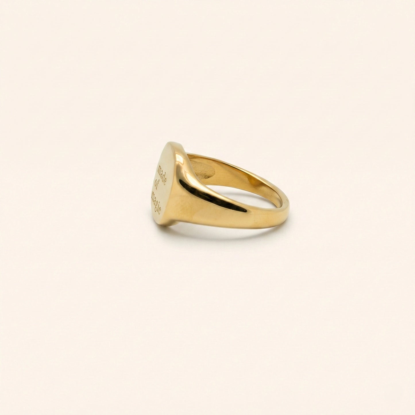 Gold ring on a beige background