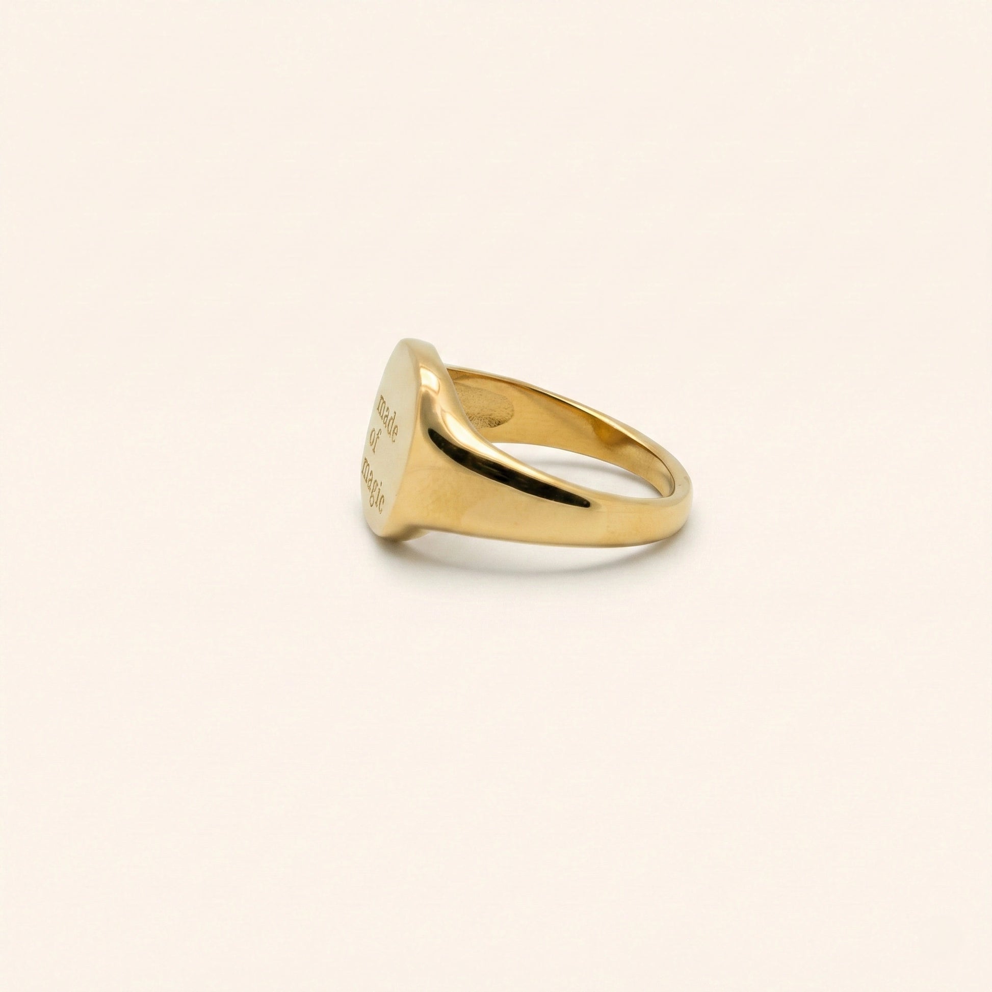 Gold ring on a beige background