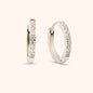 Close-up of silver huggie earring with cubic zirconia stones, waterproof and hypoallergenic