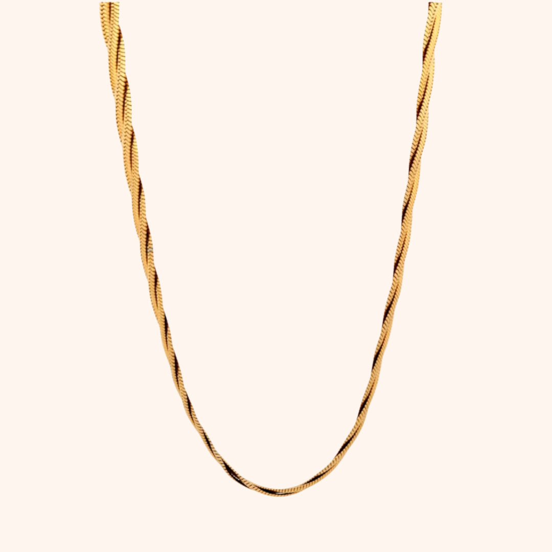 Detailed view of a gold twisted herringbone chain necklace, highlighting its smooth, fluid texture and elegant drape.