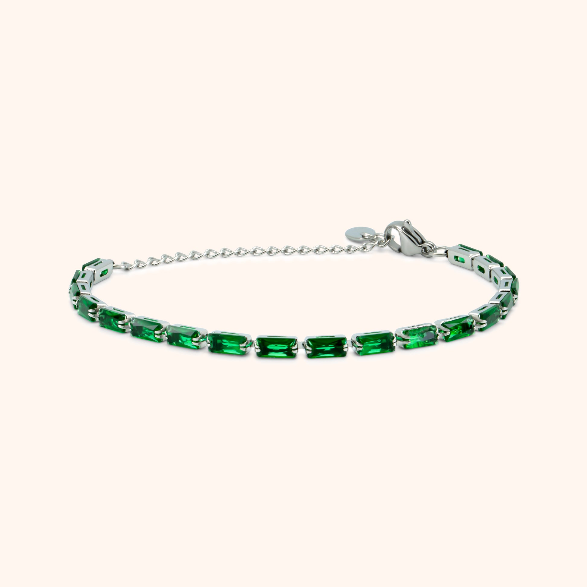 Slim silver bracelet with green baguette-cut stones and adjustable chain clasp