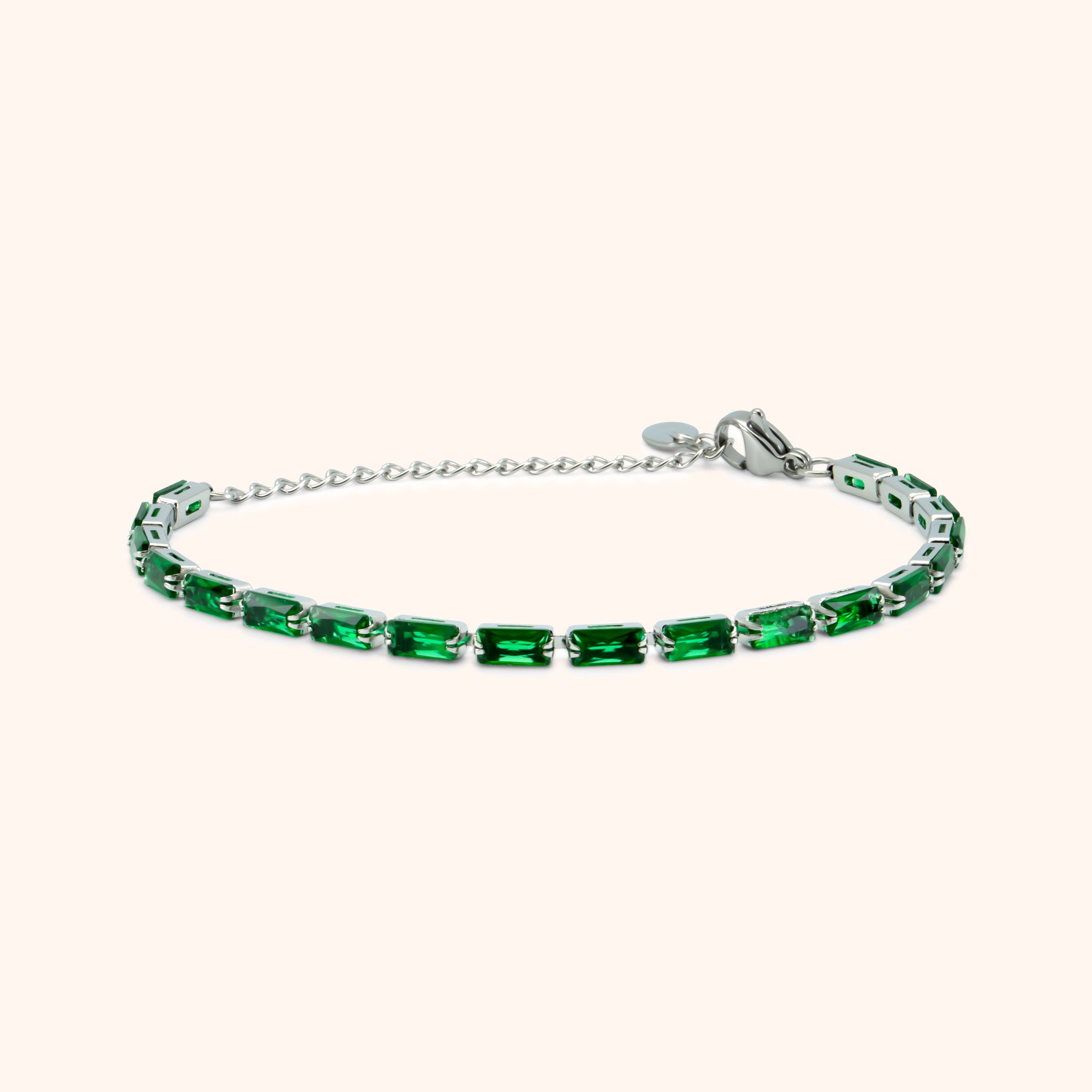 Slim silver bracelet with green baguette-cut stones and adjustable chain clasp