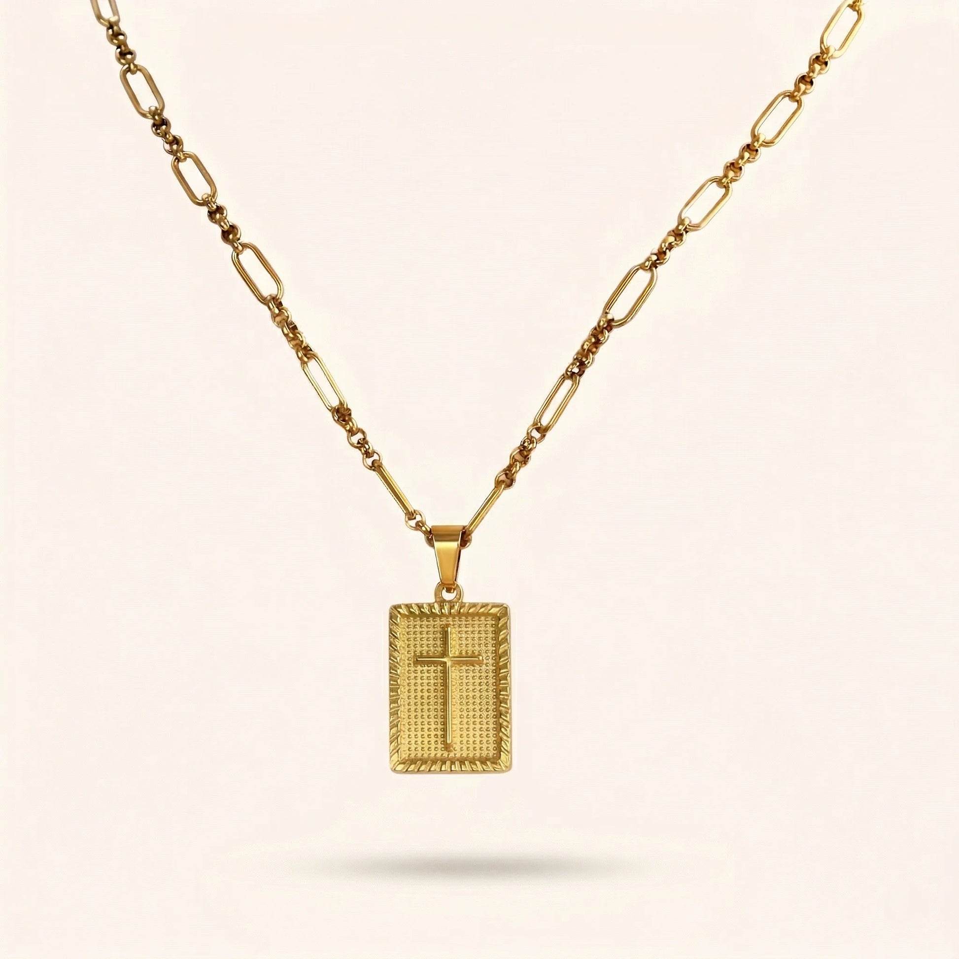 Gold necklace with a square pendant on a beige background