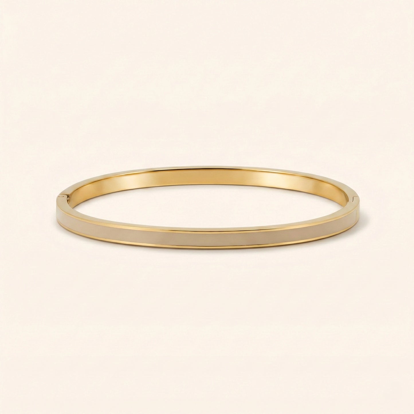 Gold bangle on a beige background