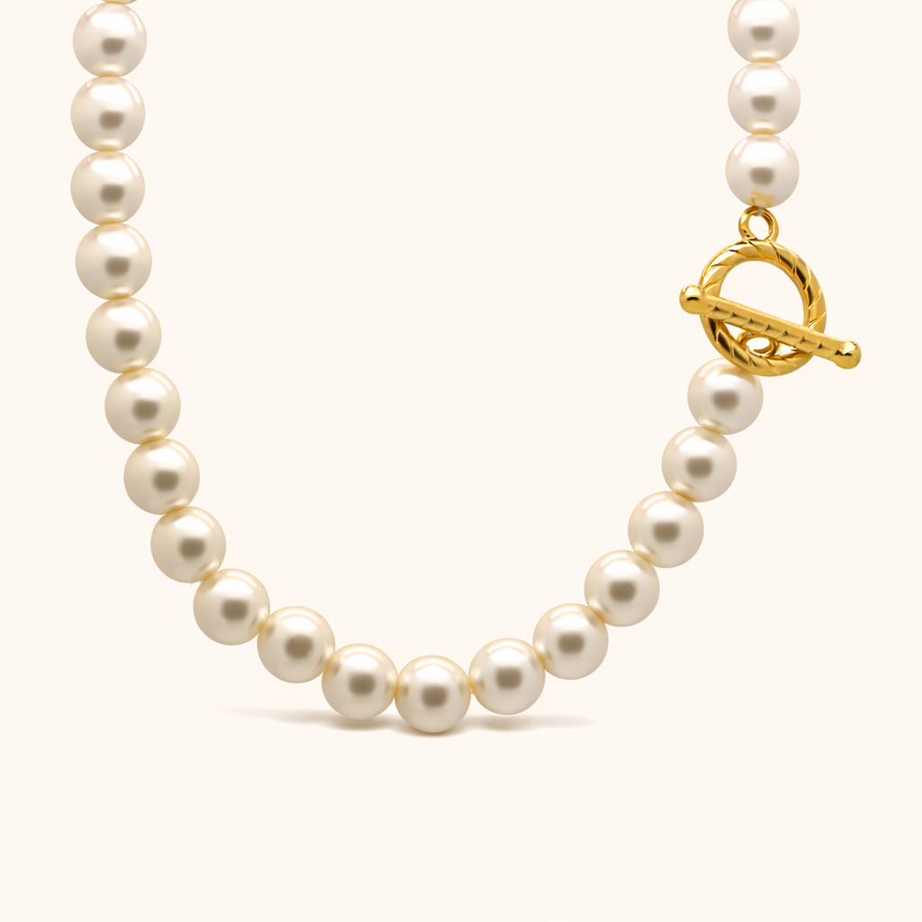 Pearl necklace with a gold clasp on a white background