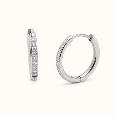 Pair of silver hoop earrings with embedded diamonds on a white background