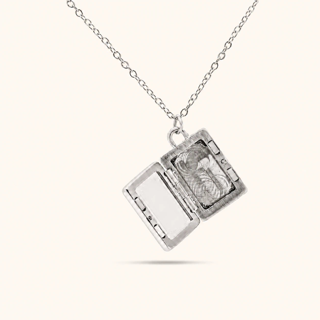Silver locket necklace on a white background