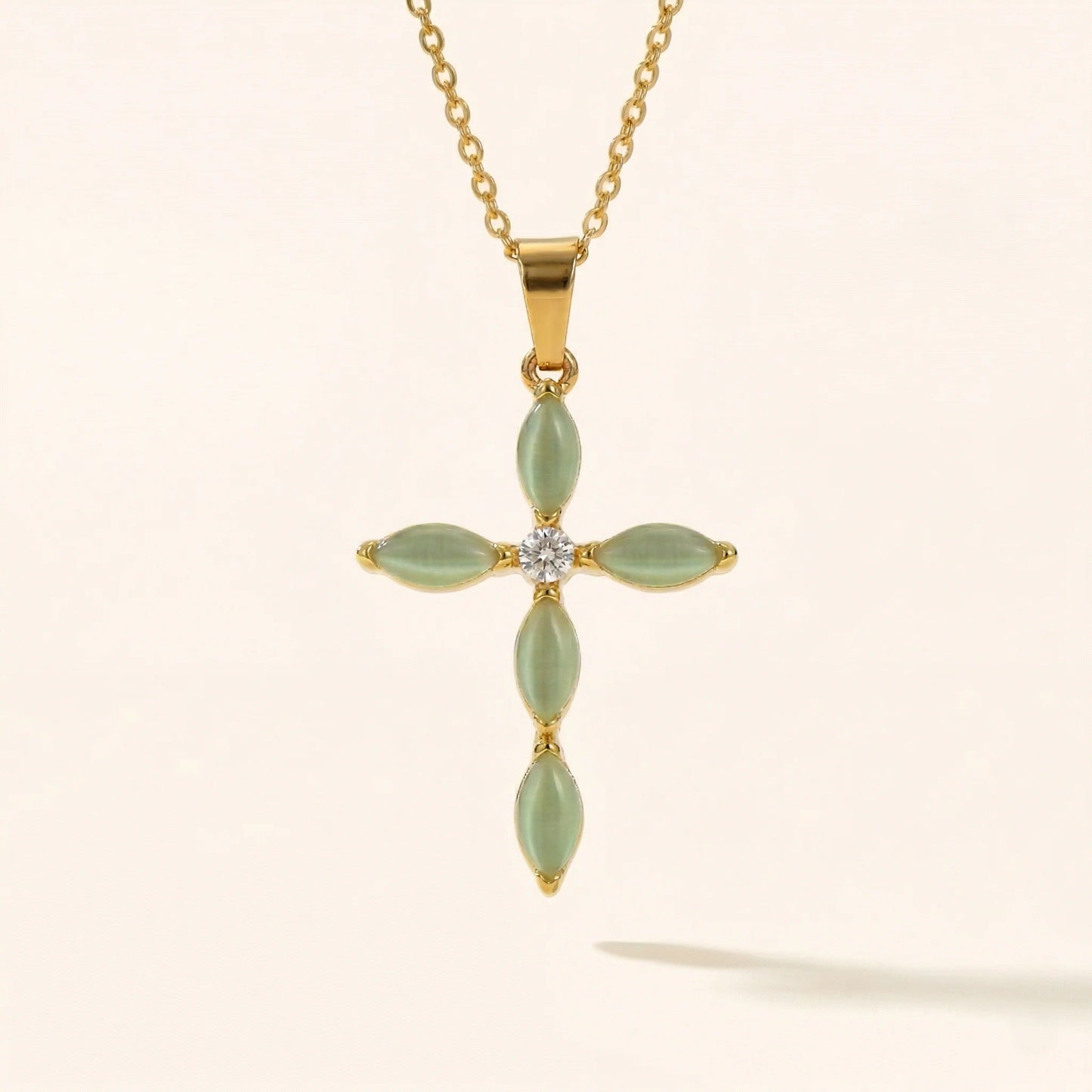 cross pendant with jade color accent stones