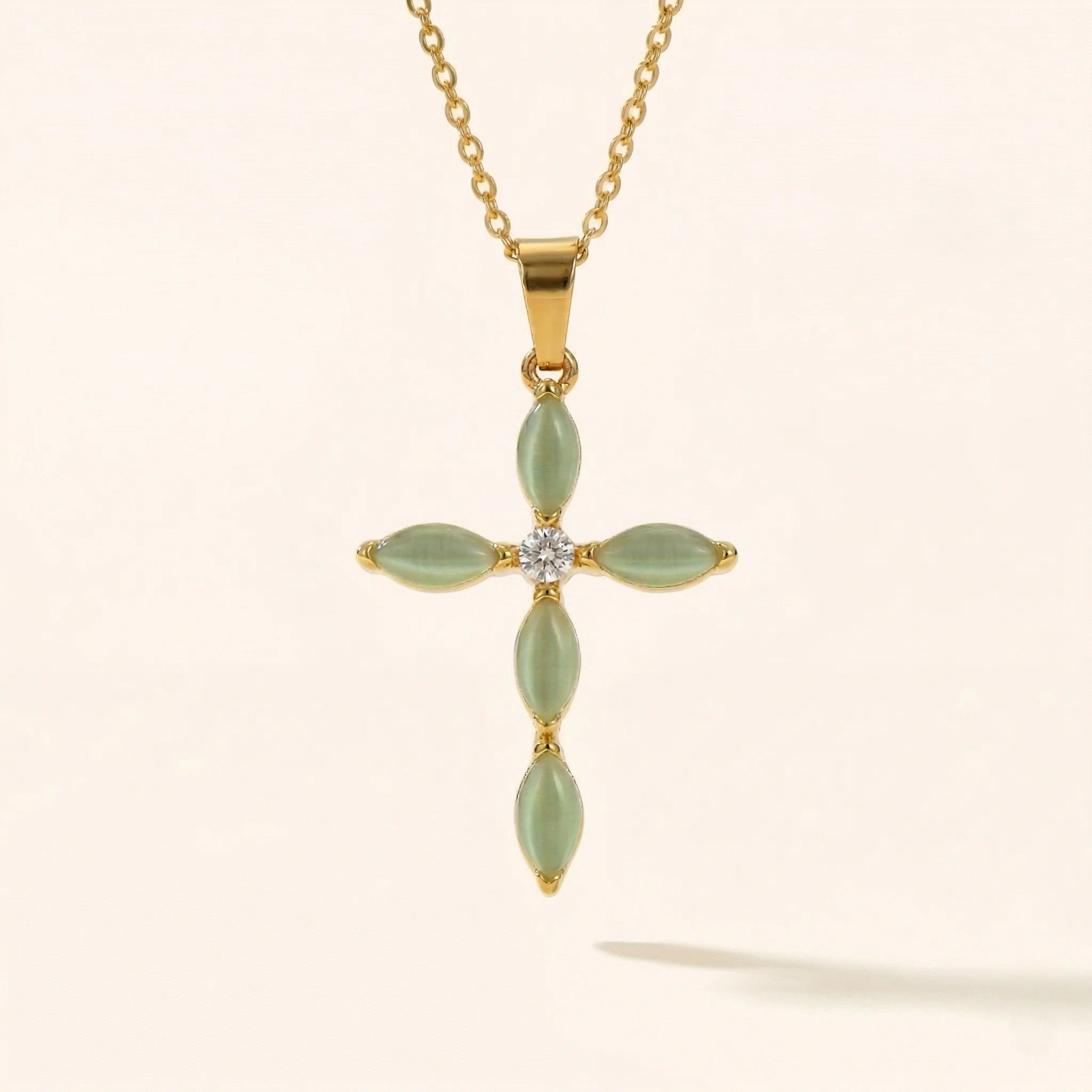 cross pendant with jade color accent stones