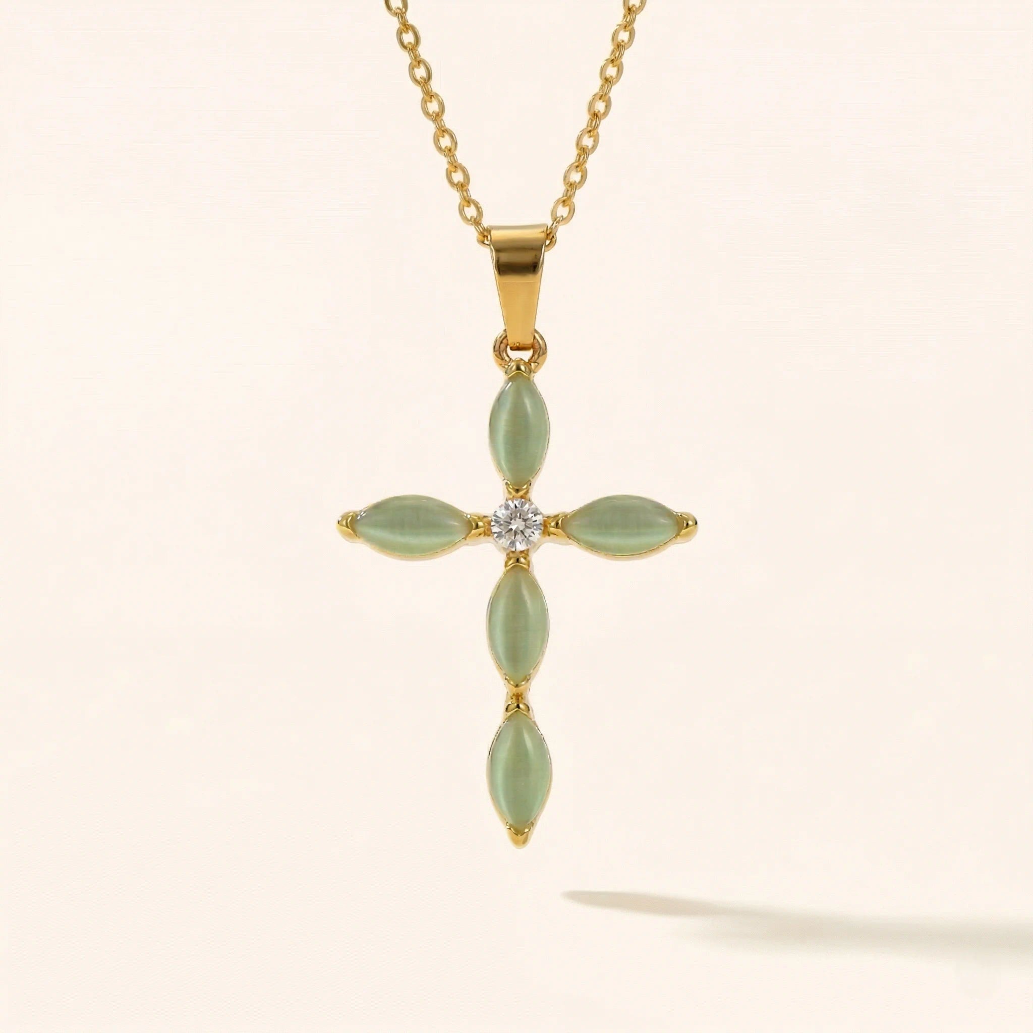 cross pendant with jade color accent stones