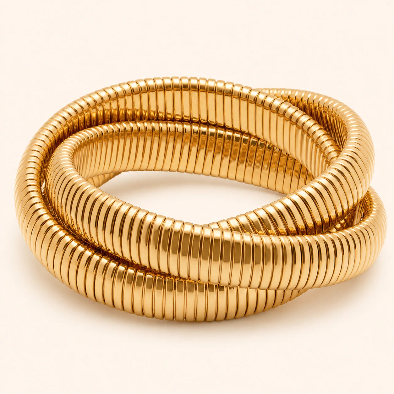 Gold bracelet on a light beige background