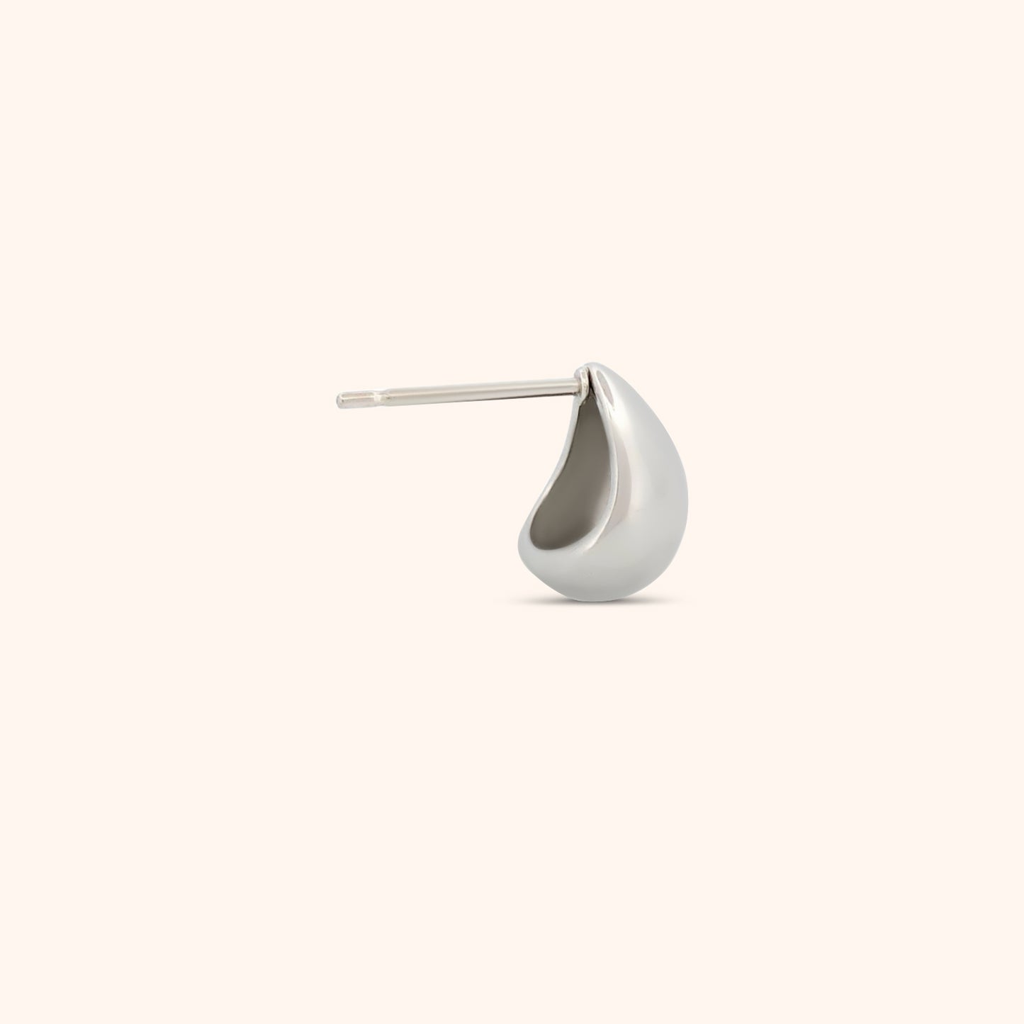 Close-up of a single teardrop earring, showcasing its smooth, reflective surface and lightweight design.